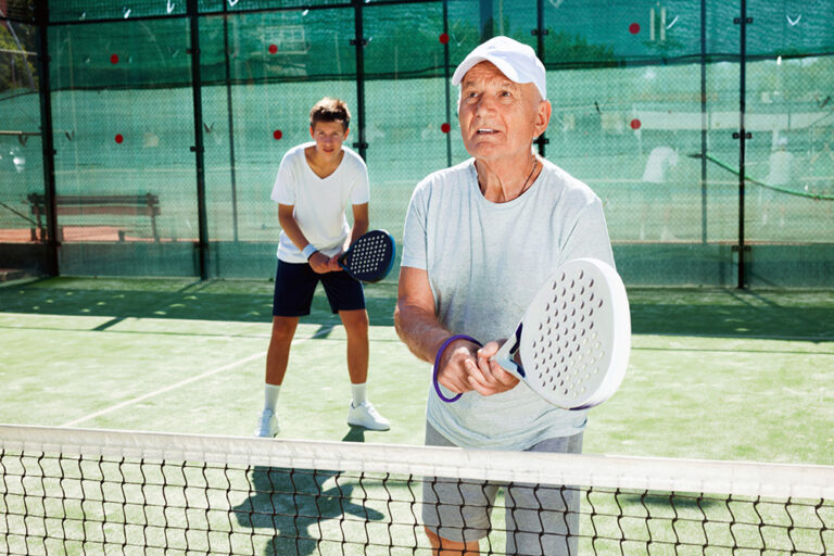 Elderly Man Playing Padel Tennis